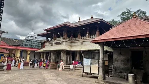 Sri Mookambika Devi Temple in Kollur during daylight, featuring traditional temple architecture and devotees, perfect spiritual experience, Karnataka tour packages.