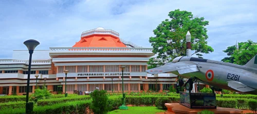 Space Museum in Thiruvananthapuram during daylight, featuring aerospace exhibits and museum building, perfect family experience, Kerala tour packages.