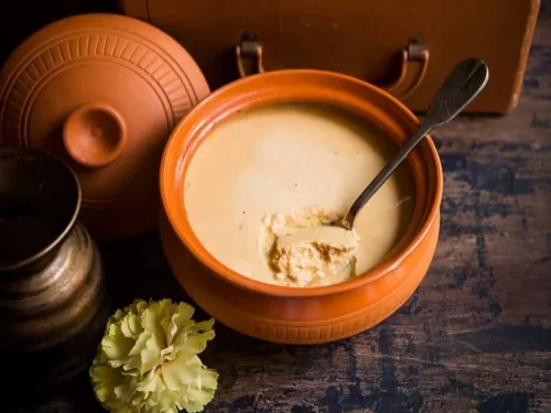 Mishti Doi in creamy caramelized sweet yogurt served in earthen pot, authentic Indian Bengali dessert with rich traditional flavors.