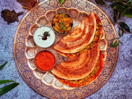 Hampi ruins at Karnataka during sunset, featuring the Stone Chariot and boulder landscape, adventure Karnataka tour package.