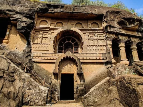 Ancient rock cut cave temple with intricate carvings and arched entrance at Pandav Leni near Nashik Maharashtra 