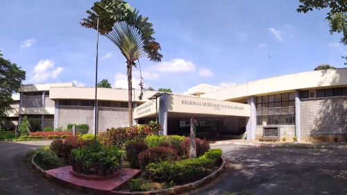 Regional Museum of Natural History Mysuru during daylight, featuring landscaped gardens and modern museum building, perfect family experience, Karnataka tour packages.