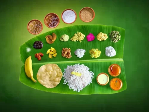 Sadya served on banana leaf with steamed rice, curries, chutneys, pickles, and desserts, authentic Indian Kerala vegetarian feast with festive traditional flavors.