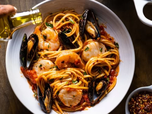 Sunset at Goa beach during evening, featuring palm trees and boats, perfect romantic experience Goa tour package.