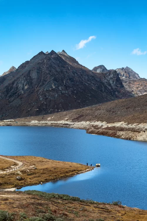 Scenic view of Sela Pass in Arunachal Pradesh with serene mountain lake and rugged peaks showcasing Himalayan beauty in Arunachal Pradesh tour packages