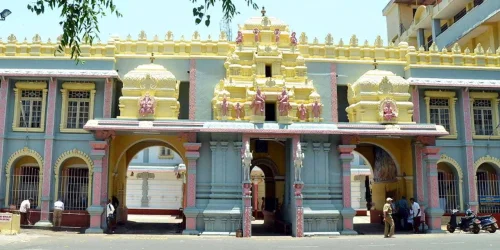 Shree Sharavu Mahaganapathi Temple in Mangaluru during daylight, featuring ornate temple entrance and colorful architecture, perfect spiritual experience, Karnataka tour packages.