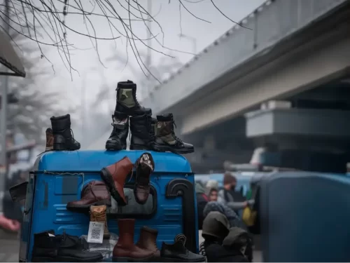 Sunday market Srinagar during foggy winter Jammu Kashmir, featuring boots shoes vendors blue truck flyover bridge backdrop, perfect Jammu Kashmir tour packages.