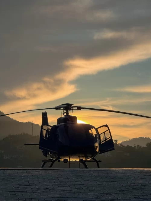 Haldwani Heli Service sunset helicopter ride with scenic mountain backdrop in Uttarakhand tour packages