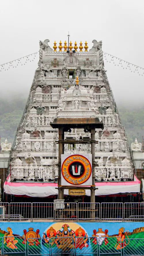 Sri Venkateswara Temple gopuram at Tirupati, Andhra Pradesh, featuring intricate white carvings and sacred symbols, a revered pilgrimage destination included in Andhra Pradesh tour packages.