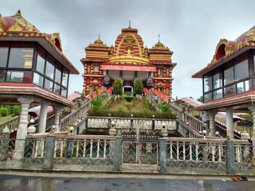 Shree Rama Kshethra in Dharmasthala during cloudy weather, featuring grand temple architecture and stone stairway, perfect spiritual experience, Karnataka tour packages.