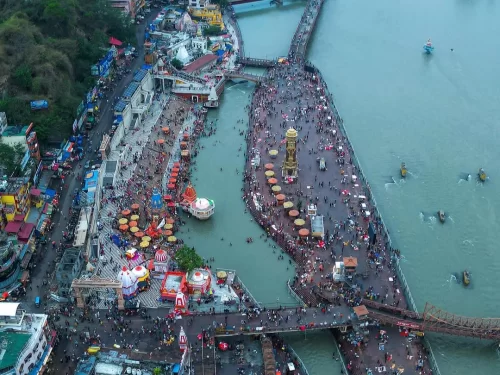Har Ki Pauri Haridwar aerial view of Hari ki Pairi tower crowded Ganga ghats colorful tents boats temples during Kumbh Mela festival, perfect pilgrimage panorama, Uttarakhand tour packages.