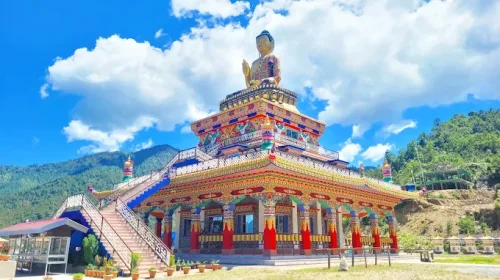 Buddha Heritage Park in Ravangla during daylight, featuring giant Buddha statue and Himalayan hills, perfect spiritual experience, Sikkim tour packages.