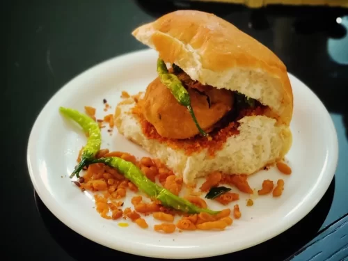 Gateway of India Mumbai at sunset, featuring boats and reflections, romantic Maharashtra tour package.