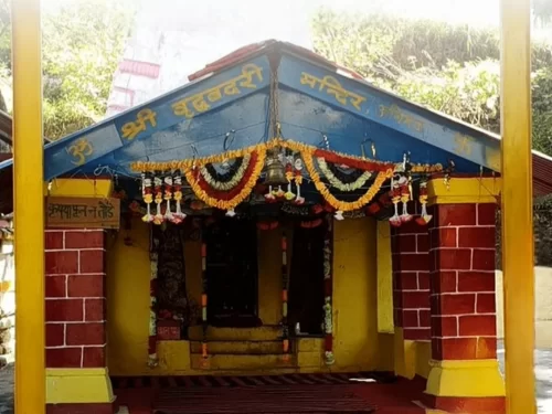 Shri Vridh Badri Temple near Joshimath, Uttarakhand adorned with colorful pillars and floral decorations, a sacred Panch Badri site included in Uttarakhand tour packages
