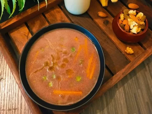 Zan, a traditional Kashmiri warming soup with rich yogurt-based broth, mild spices and nuts, comforting Indian cuisine delicacy.